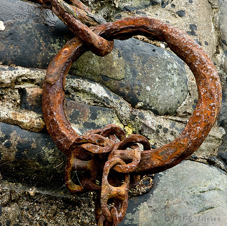 Rusted ring and chain on stone