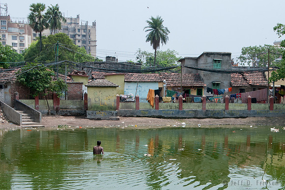 Men bathing in a polluted pond